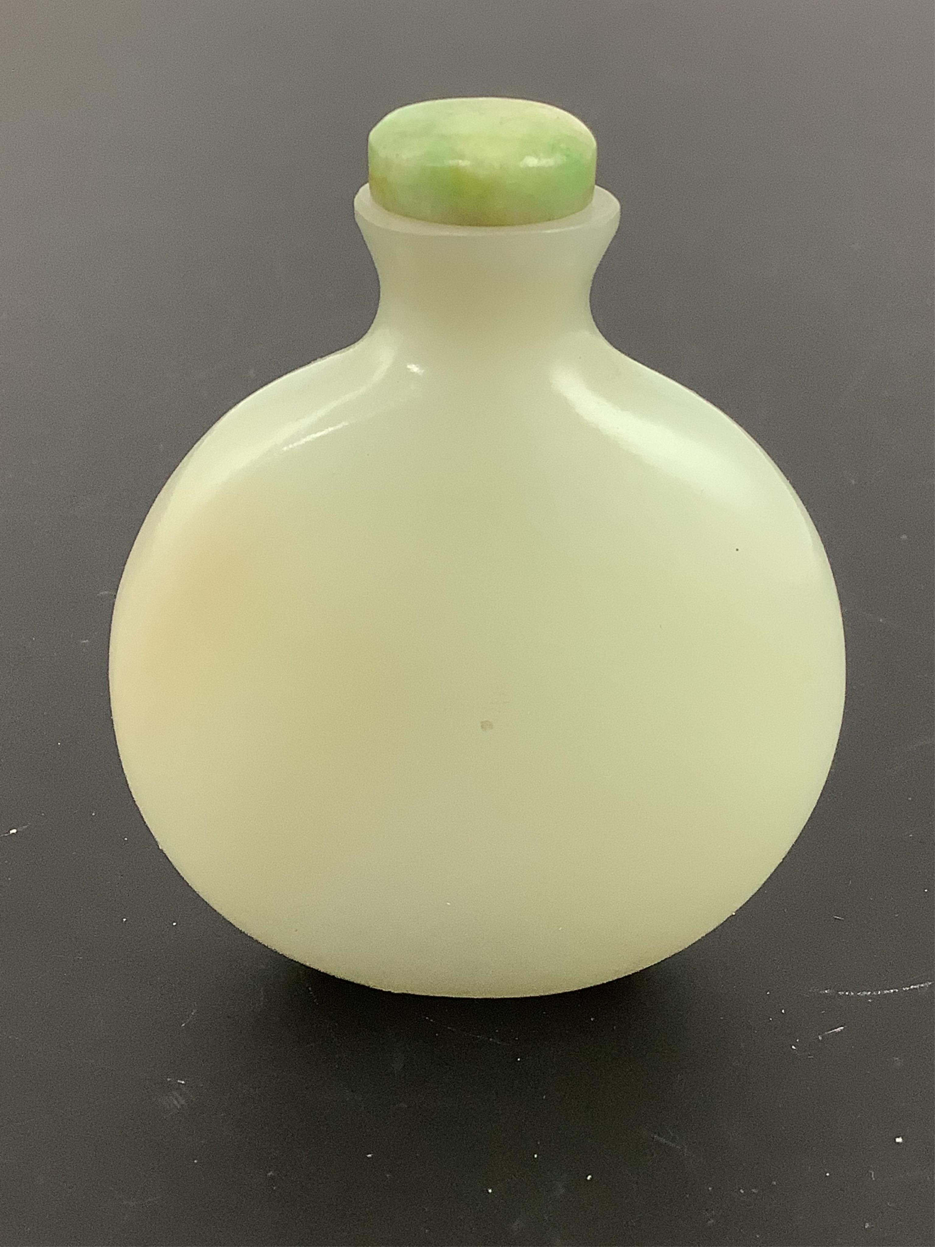 A Chinese pale celadon jade snuff bottle, of moonflask form, 19th century